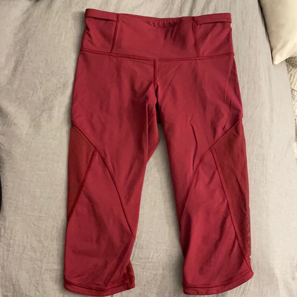Burgundy Lululemon below the knee workout leggings.